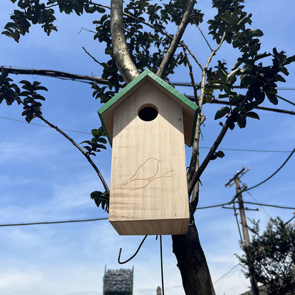 Wooden birdhouse hanging high on tree with hook - outdoor wild bird nesting box in garden setting
