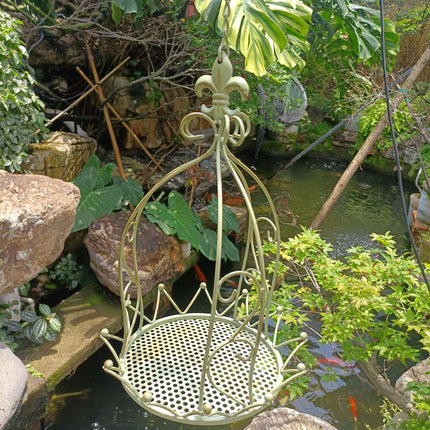 Iron planter basket hanging on wall with green foliage - garden home patio decor vintage style