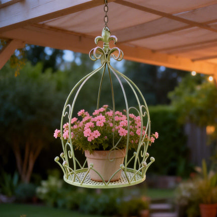 Close-up detail of vintage iron hanging planter crown top - ornate metalwork scroll design garden decoration